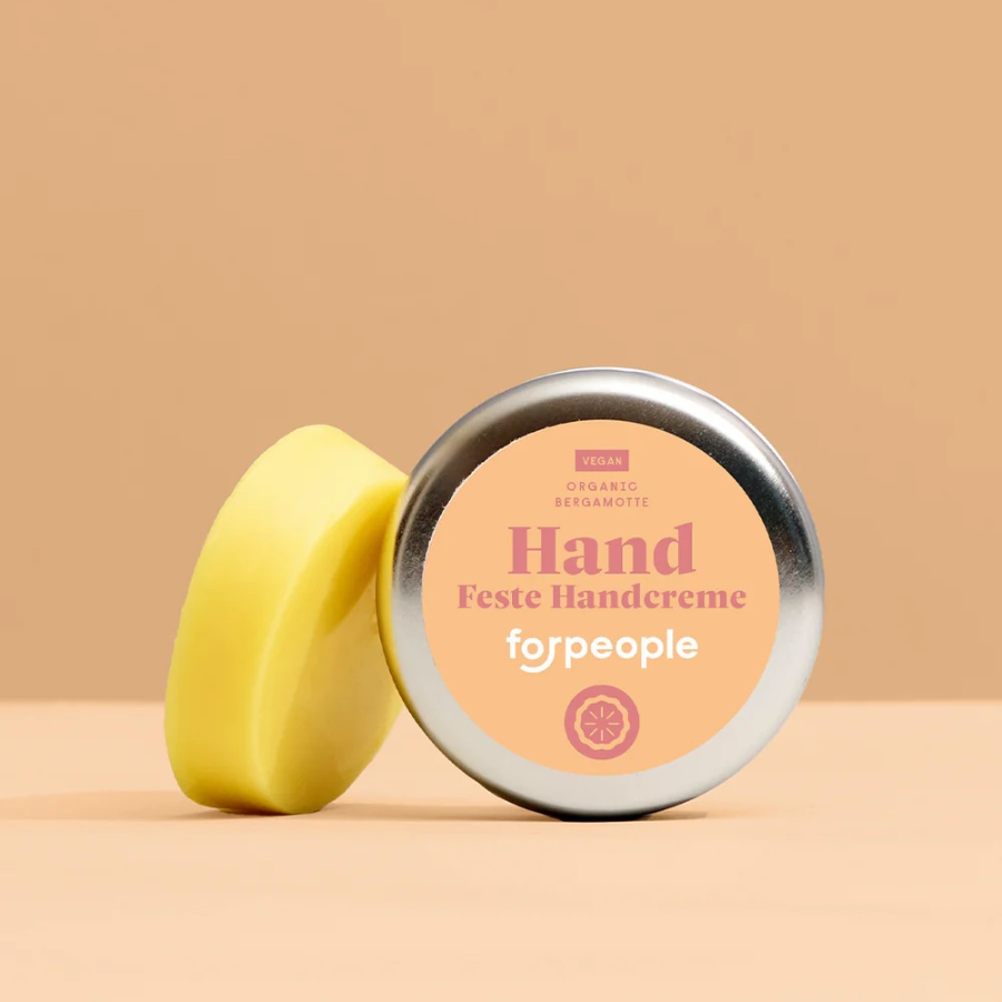 Feste Handcreme – Bergamotte (vegan) von forpeople mit Dose vor orangen Hintergrund