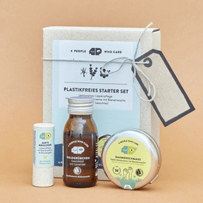 Plastikfreies Starter Set – Verpackung und Inhalt, mit Bienenwachs vor orangenen Hintergrund