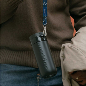 Person trägt Person den Travel Mug 400 ml Black von Dopper in der Hand