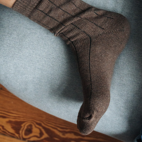 Person trägt Stricksocken von Salzwasser in Braun 
