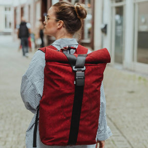 Person trägt den roten airpaq Rolltop Biq auf dem Rücken