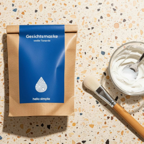 Gesichtsmaske – weiße Tonerde von hello simple – Verpackung von vorne mit Pinsel und Schale