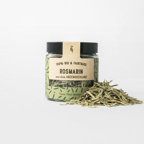 Rosmarin in Glasverpackung mit Gewürzhäufchen von vorne 