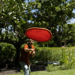 Person wirft Ultimate Moon Disc Orange